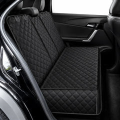 Black quilted car seat liner set installed on a vehicle's front and rear seats, shown from the open rear door.