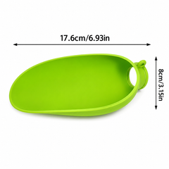 A bright lime green silicone scoop or spoon with a circular hole at one end, shown with black dimension arrows and text indicating a width of 17.6cm (6.